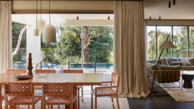 Open plan dining and living room with exterior view to pool