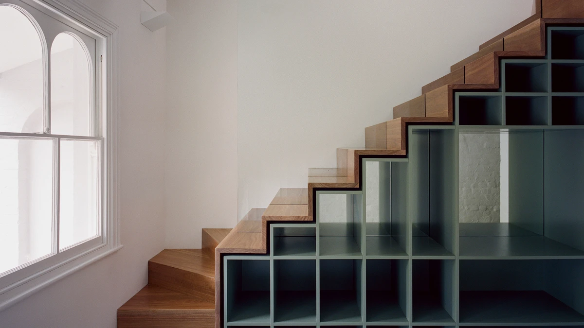 Staircase with shelving underneath.