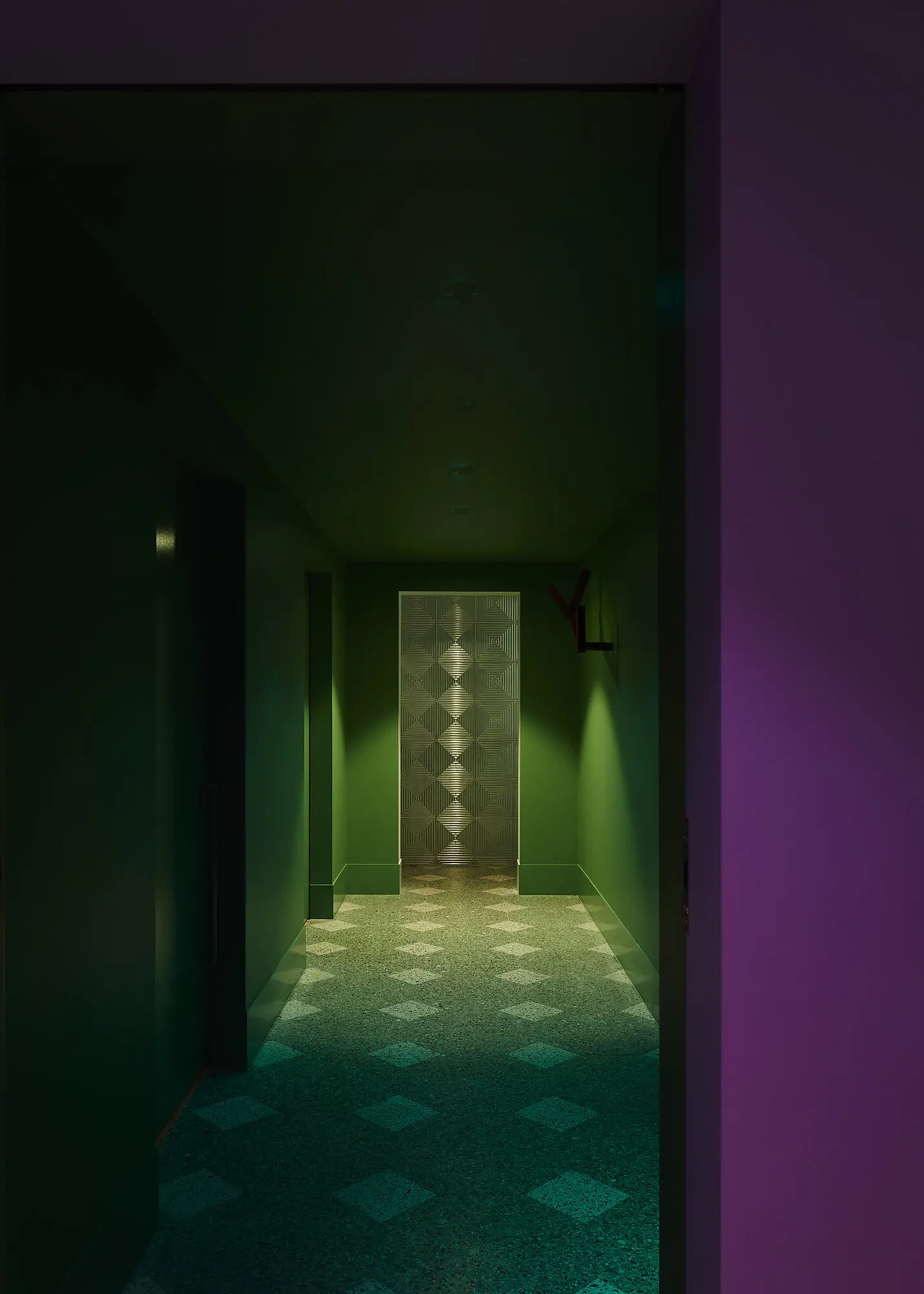 Corridor with purple entry and green carpet and walls.