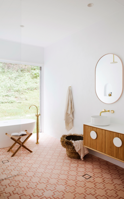 hinterland bathroom in Dulux White on White ceiling and walls with terracotta-coloured floor tiles and freestanding bath