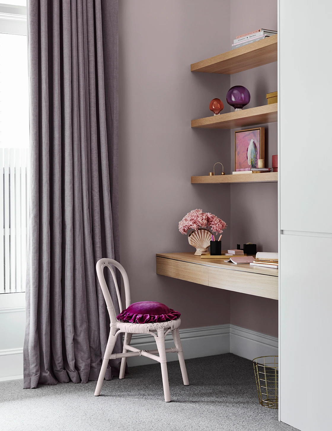 Light purple study with built-in desk and shelves. Floor-length drapes, white bentwood chair with plush purple velvet cushion