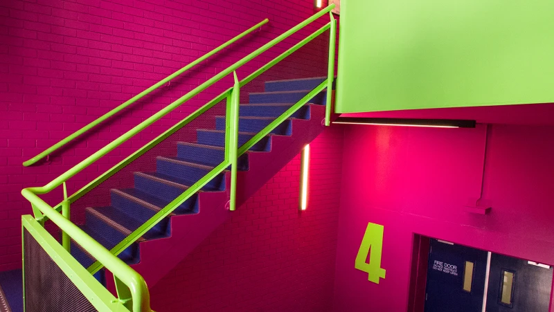 Hot pink, deep purple and lime emergency fire stairwell