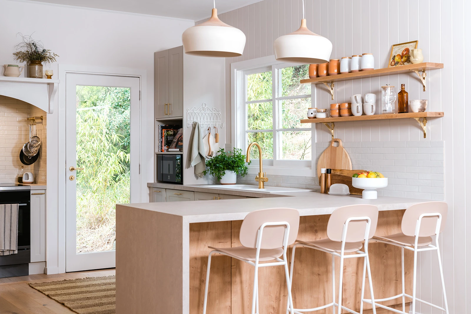 White kitchen interior with timber bench and pendant lighting