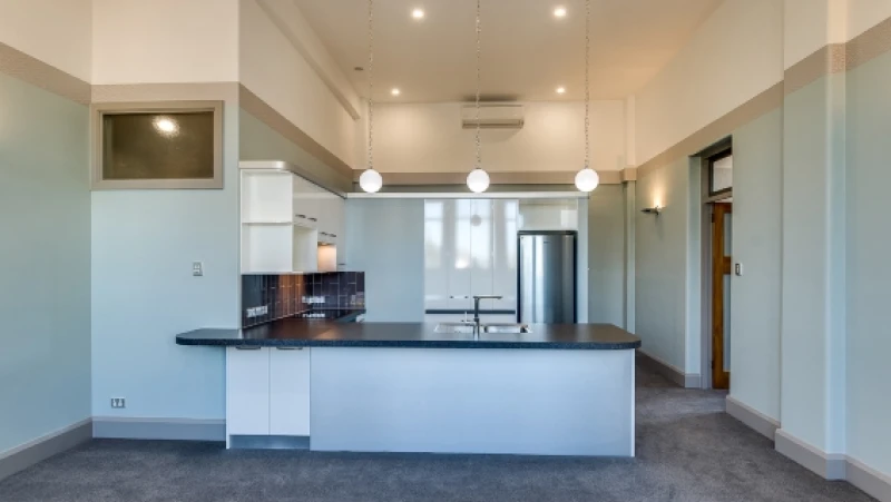 Blue kitchen with black benches