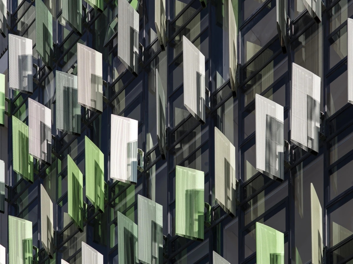 Multi-level apartment building with green and white louvres