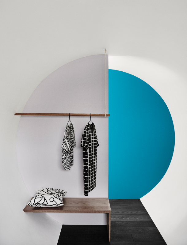 Grey, white and blue dominate a tubular shaped dressing room with wooden bench.