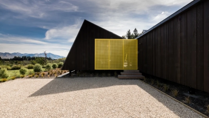 Modern black house with yellow metal panels