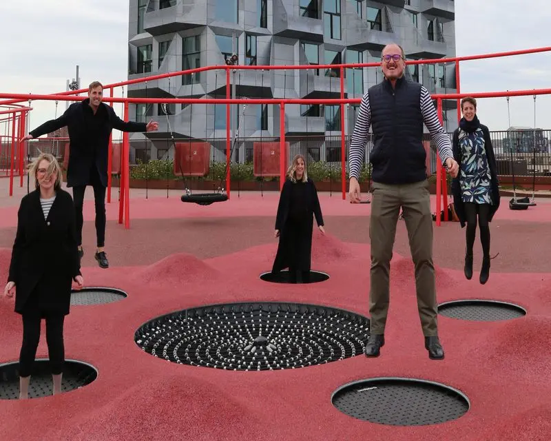 Men and women bouncing on mini trampolines
