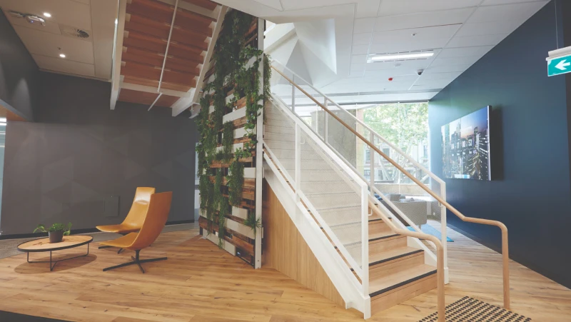 White and timber office stairs with navy and grey walls