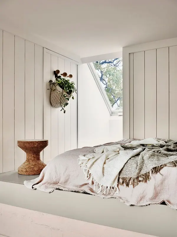 Monochromatic white bedroom scheme with skylight