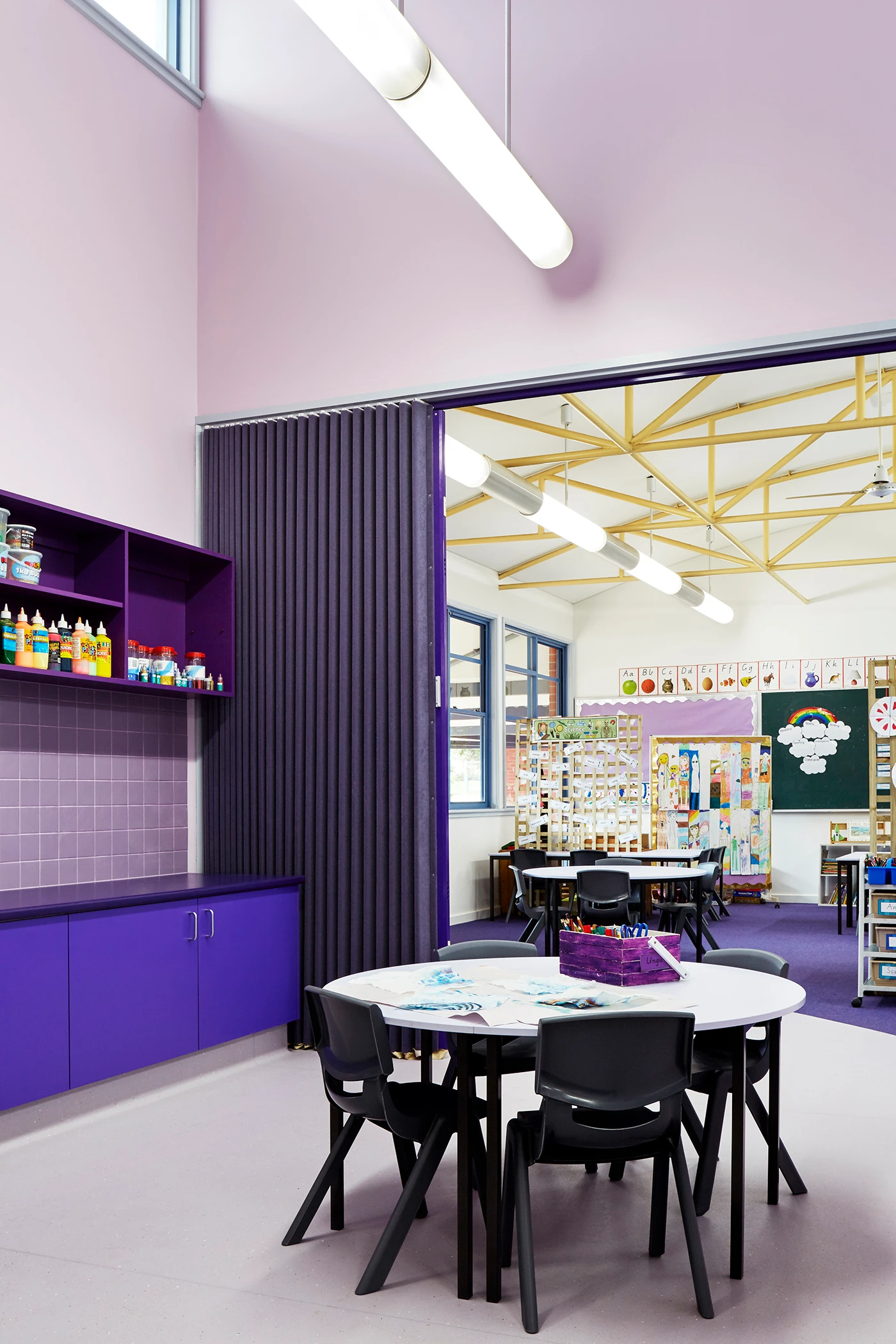 Purple classroom with chairs and table