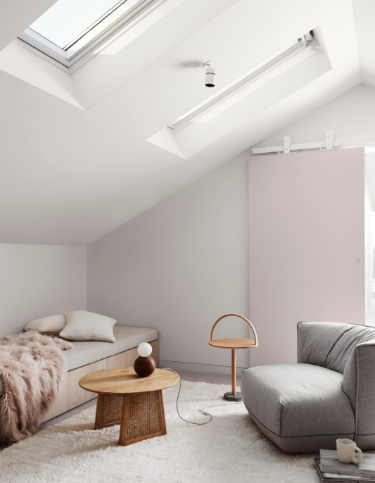 White Japandi interior with sloped ceiling and skylights