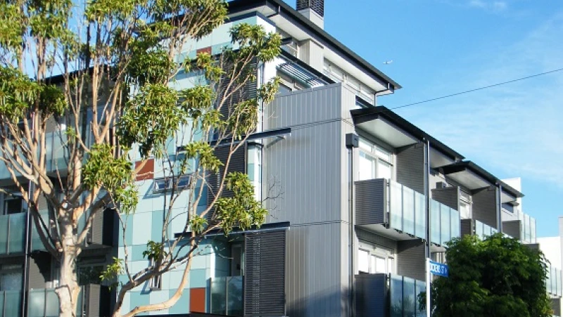 White apartment building with coloured panels