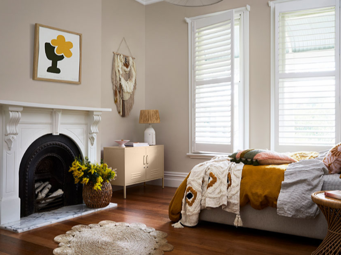 interior cream bedroom with fireplace and warm tones.