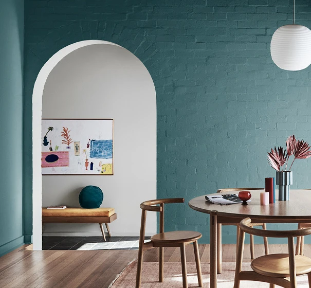 Teal dining room with wooden floors and dining setting