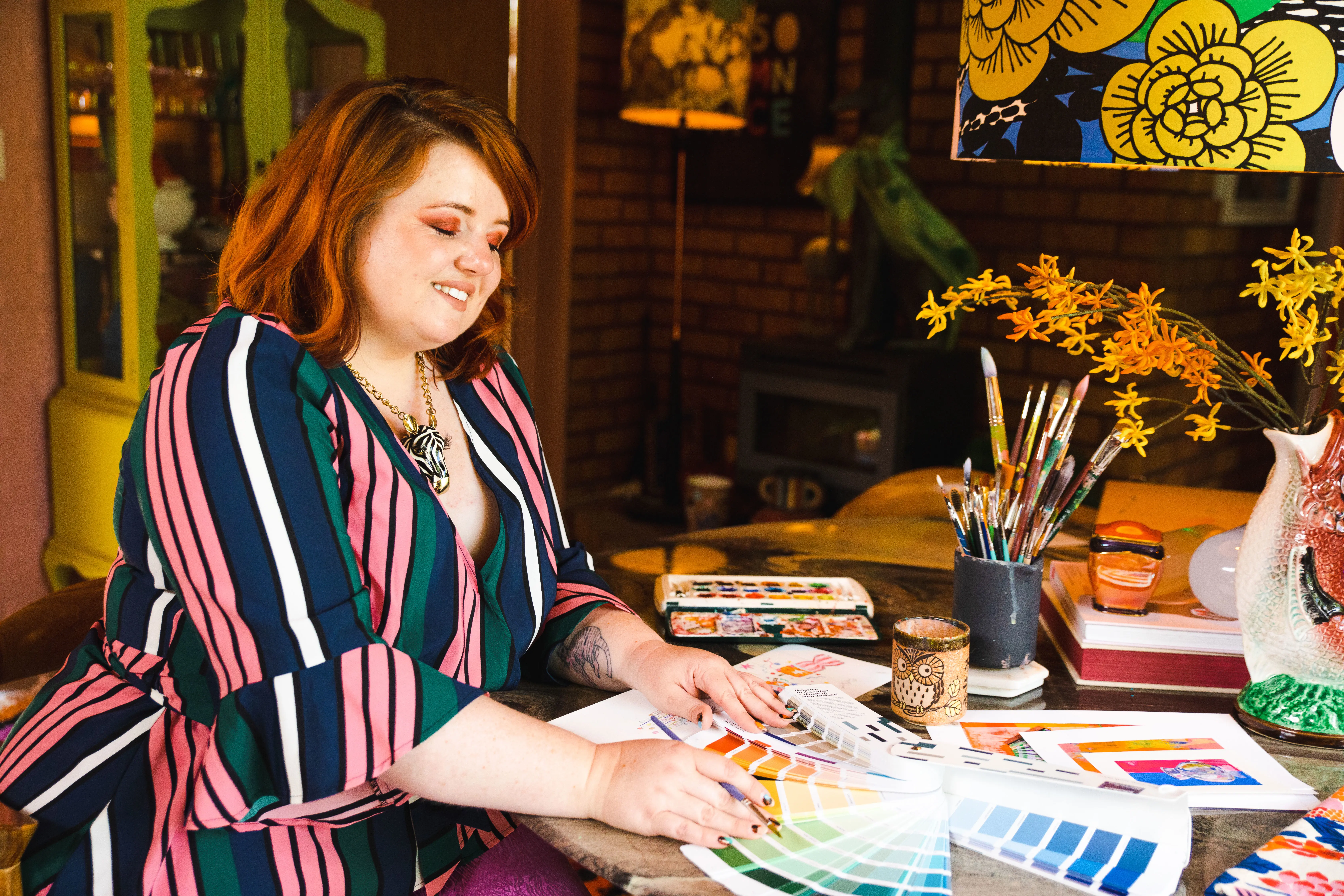 Evie Kemp looking at a Dulux colour fandeck