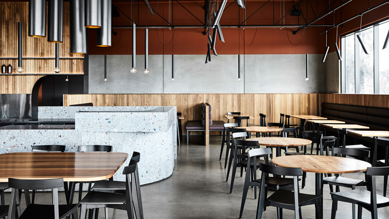 interior dining setting with concrete and wooden decor.