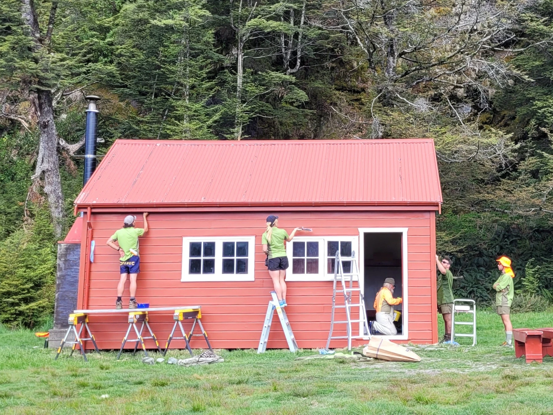 Red Hut being painted and renovated by 5 people