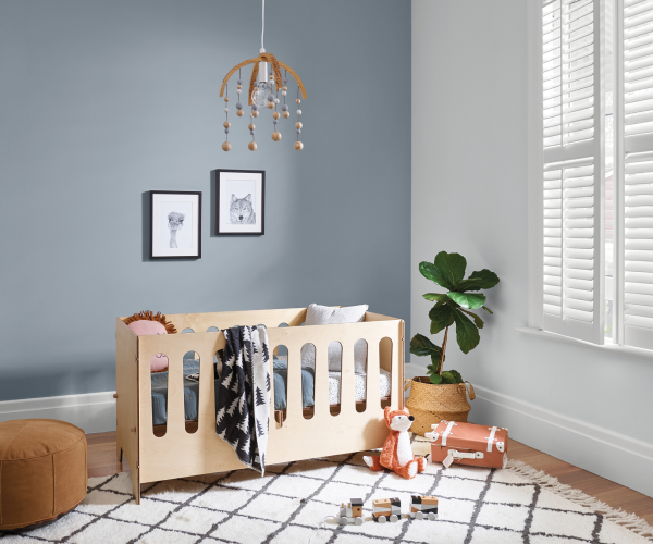 Nursery with white walls and trims and blue/grey feature wall