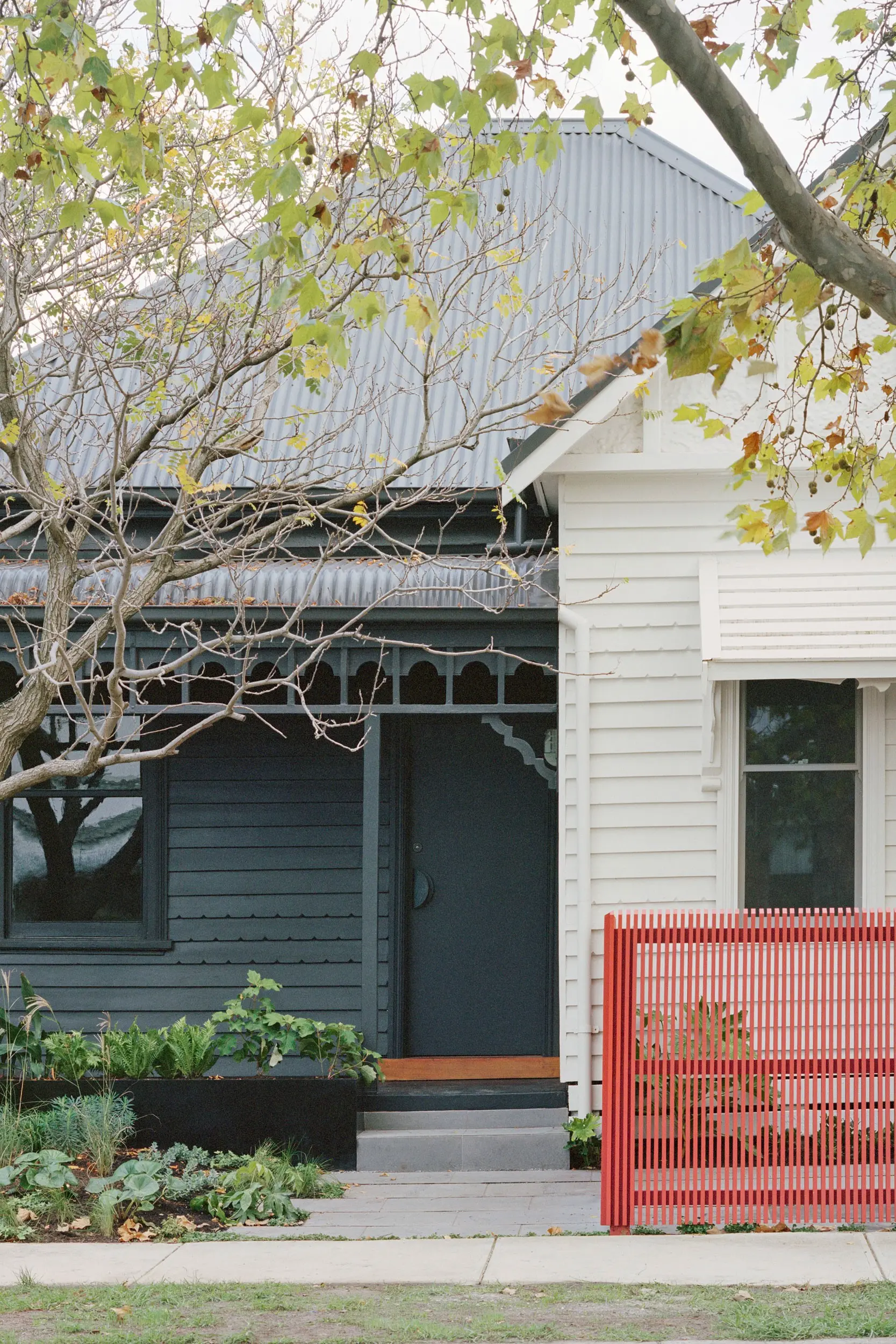 Double-fronted Victorian weatherboard house in cream and grey.