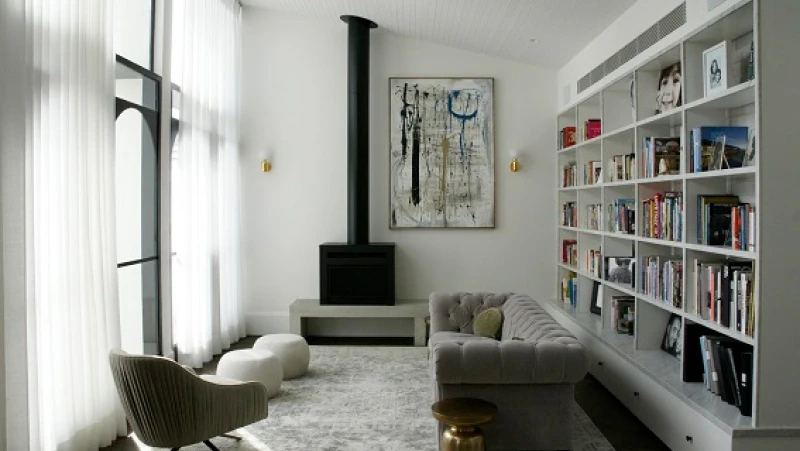 White living room with built-in bookshelf