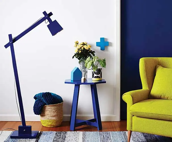blue lamp next to a blue side table and blue accessories