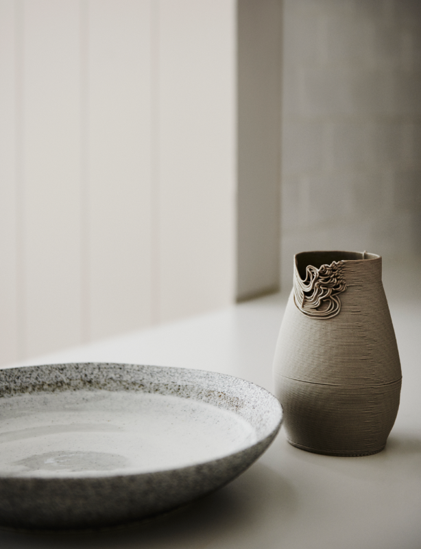 Ceramic platter and vase with textured edge in neutral colours on bench.