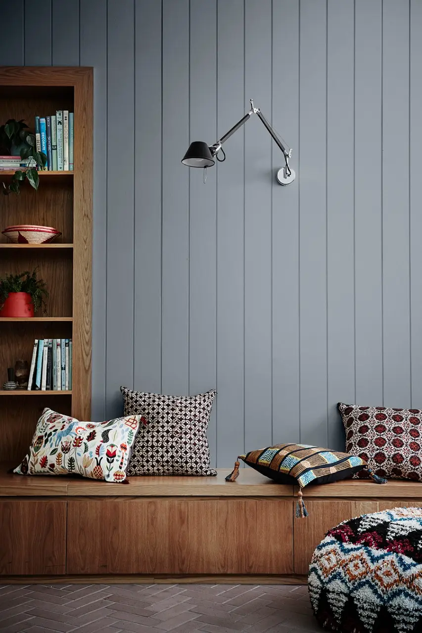 interior blue bench seat with self and lamp.