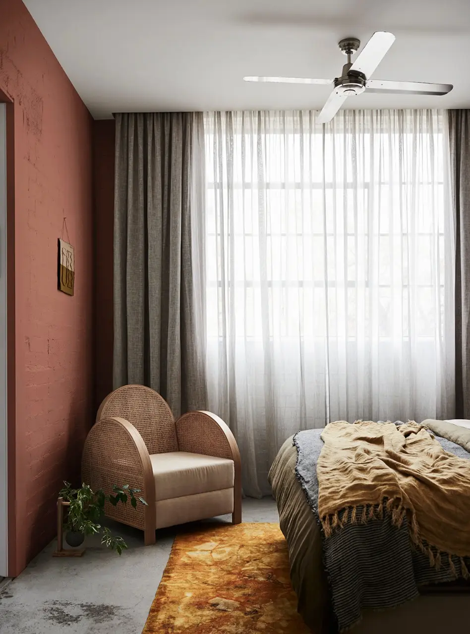 interior pink walled bedroom with chair. 