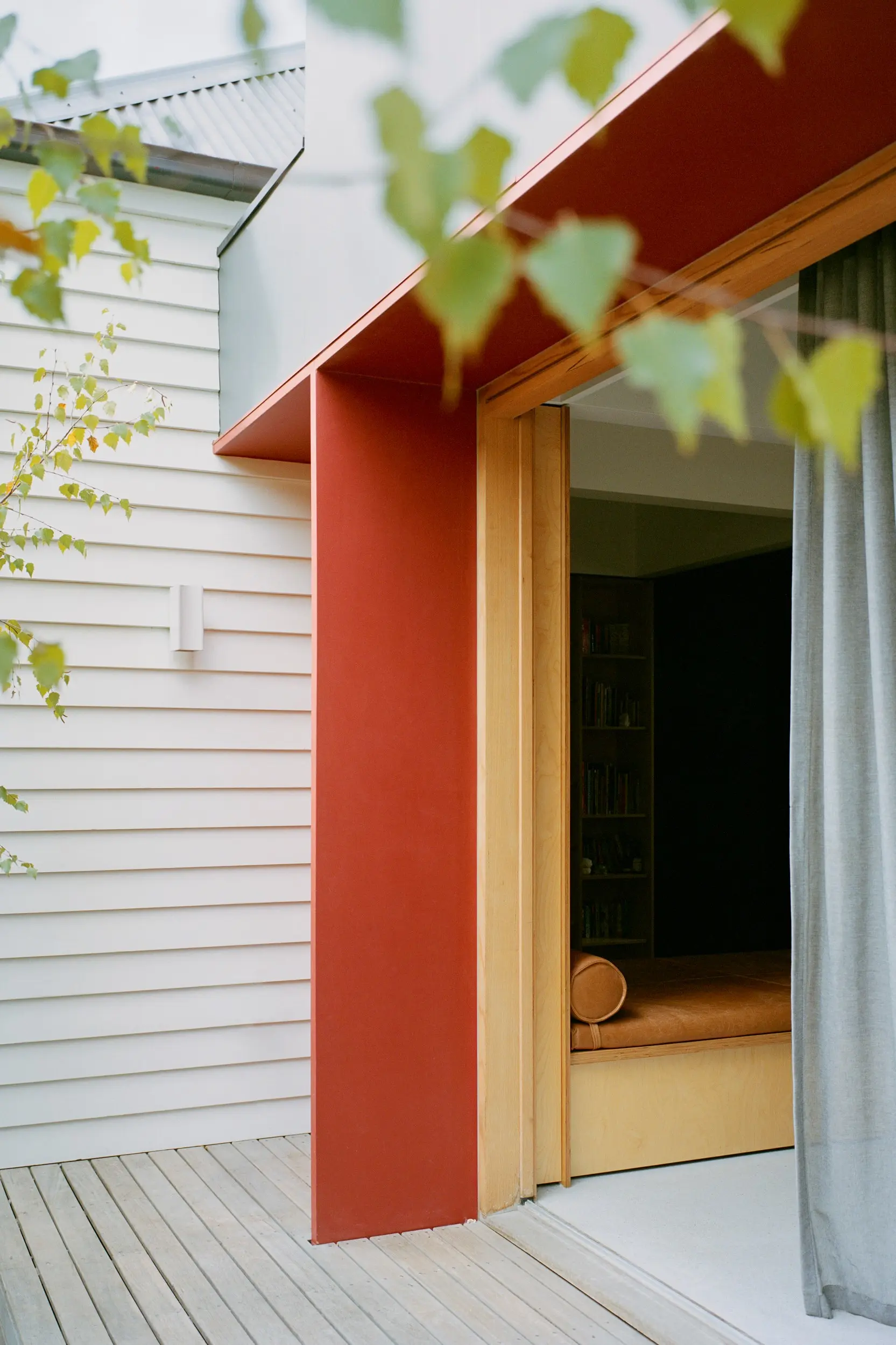 Exterior corner of red and cream house