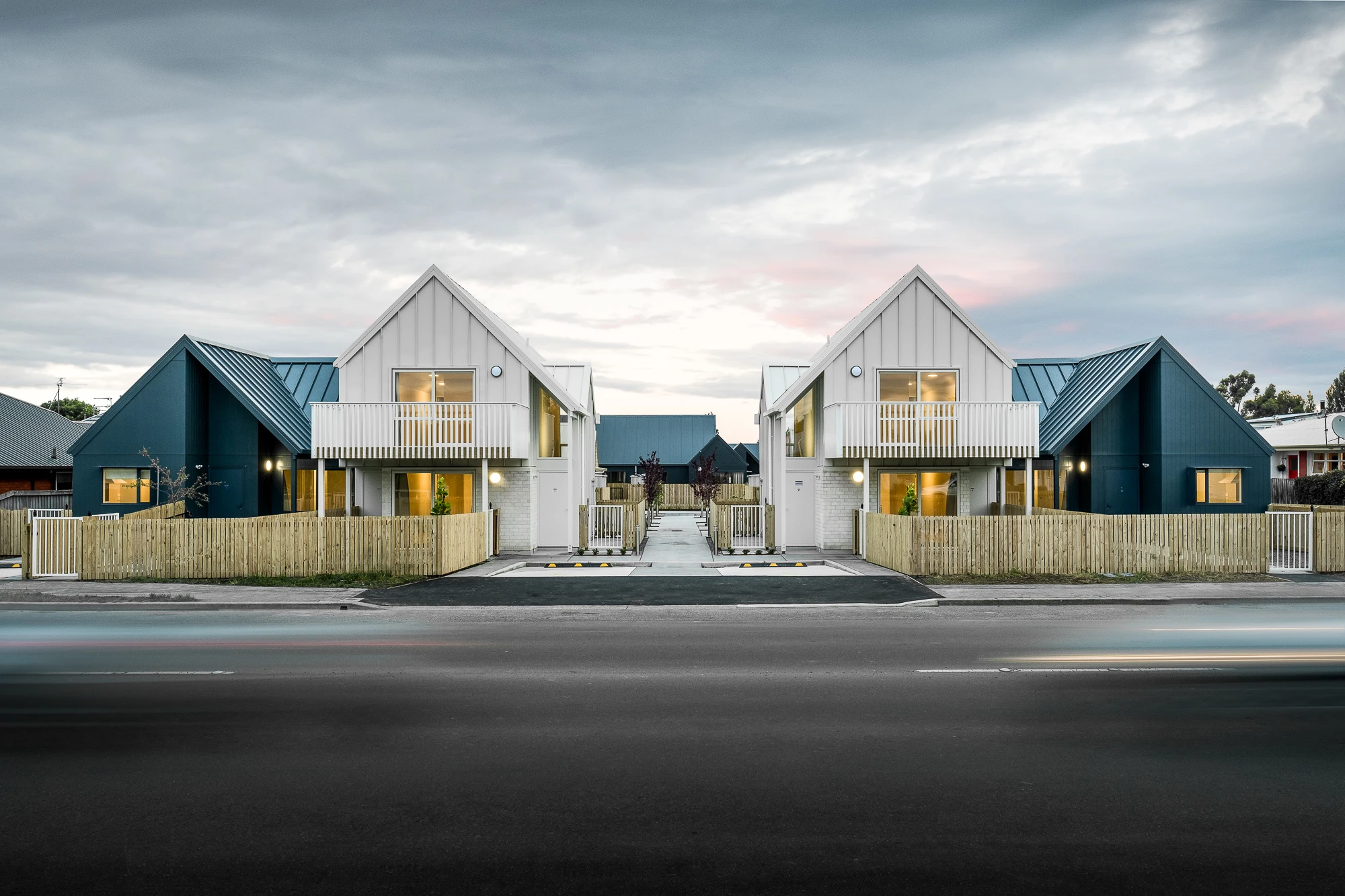 View from the street of two blue and white houses