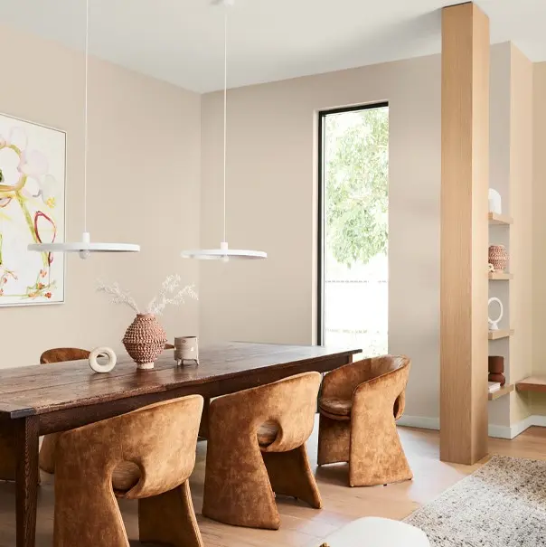 Neutral dining room with tan chairs and timber dining table