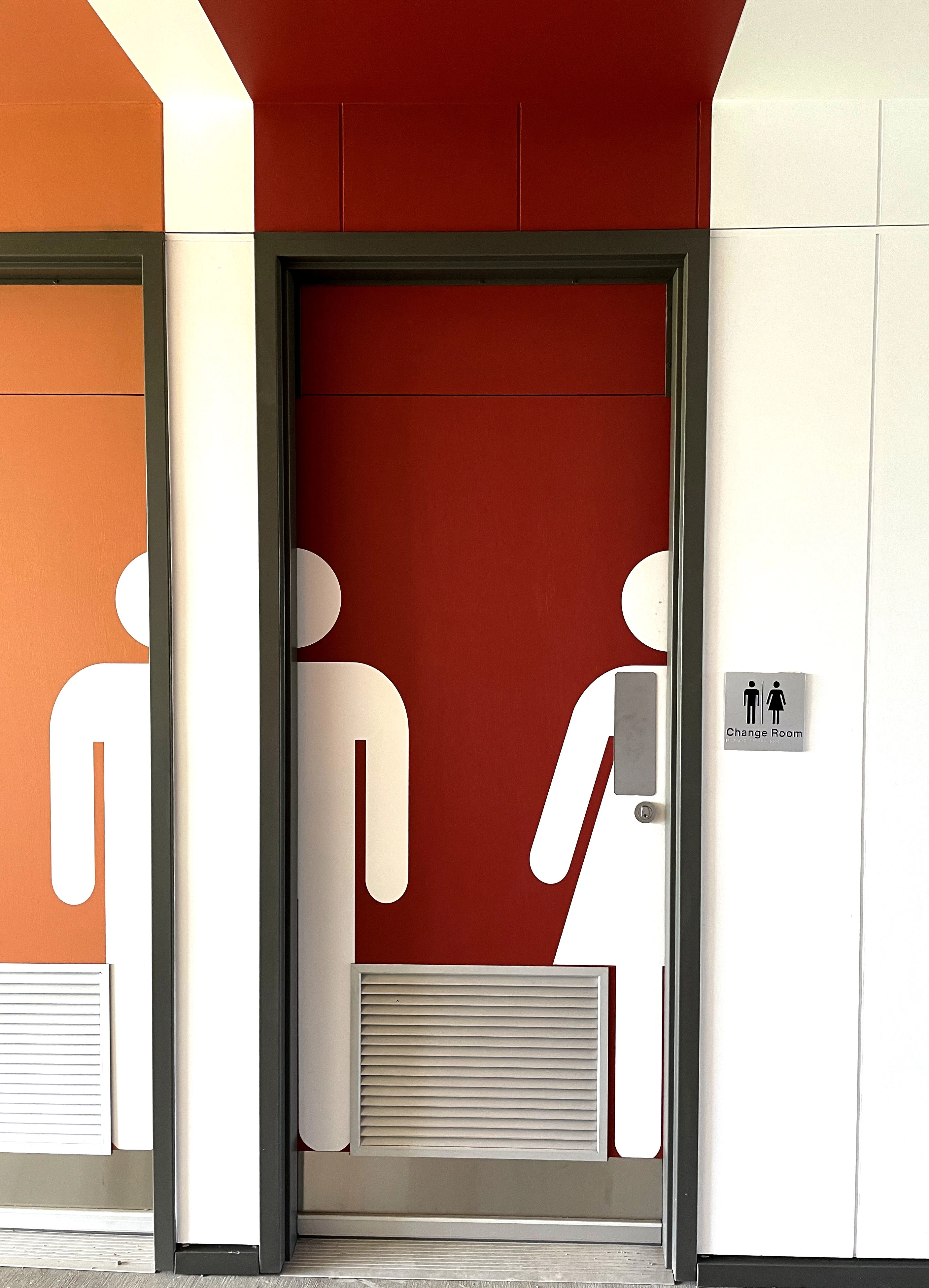Orange and maroon doors to joint mens and womens change rooms.
