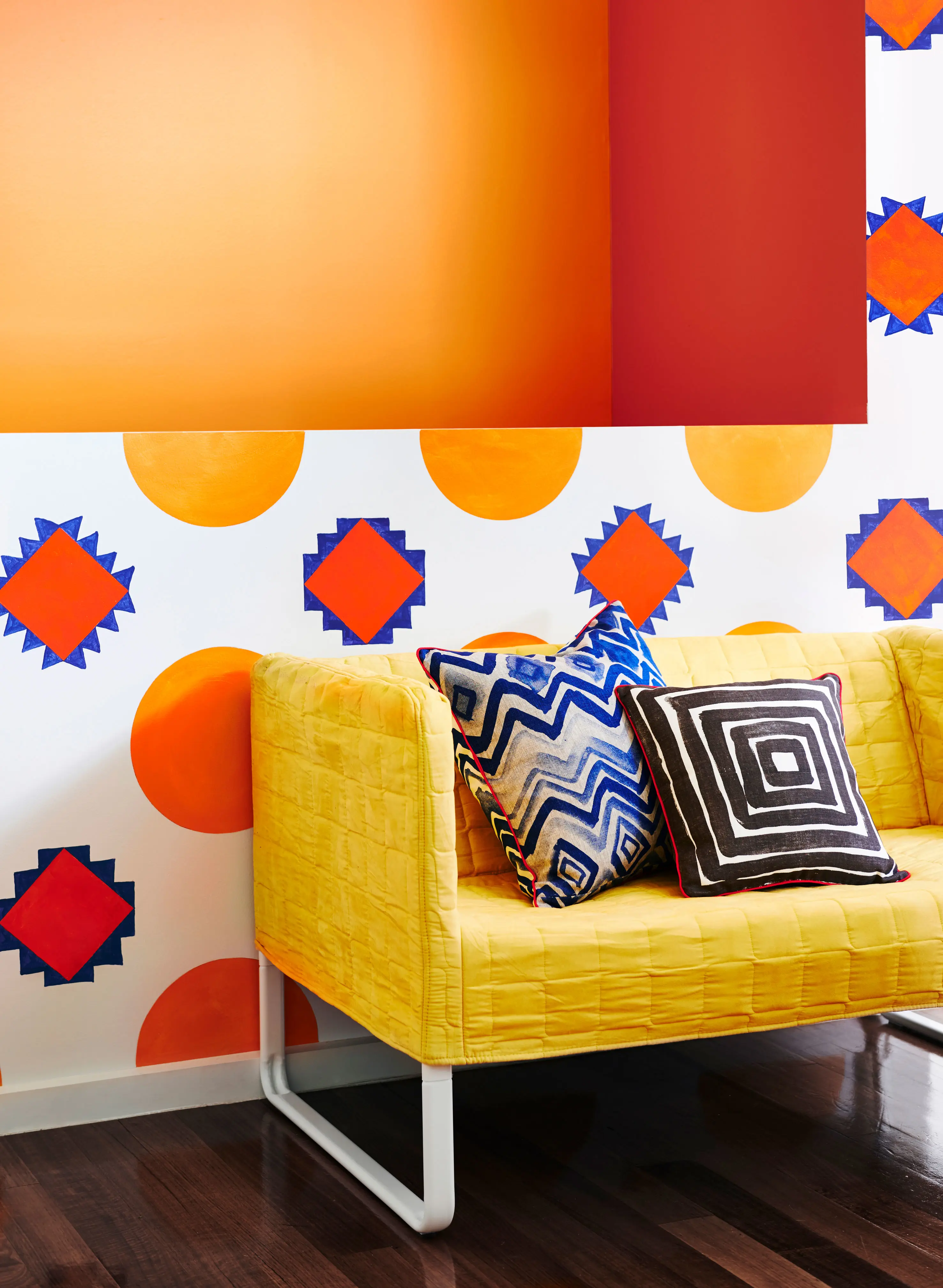 Orange and white patterned living room with yellow couch