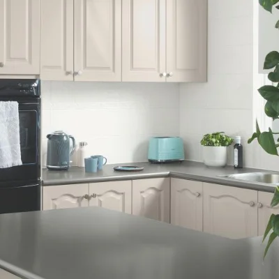 Kitchen with cream cabinets and white tiles