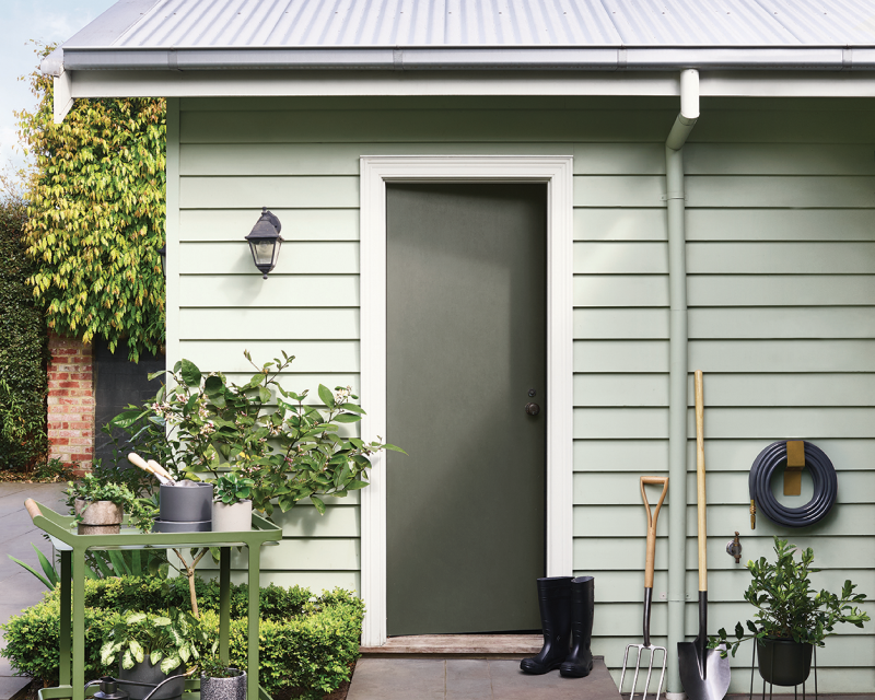 exterior green weatherboard shed. 