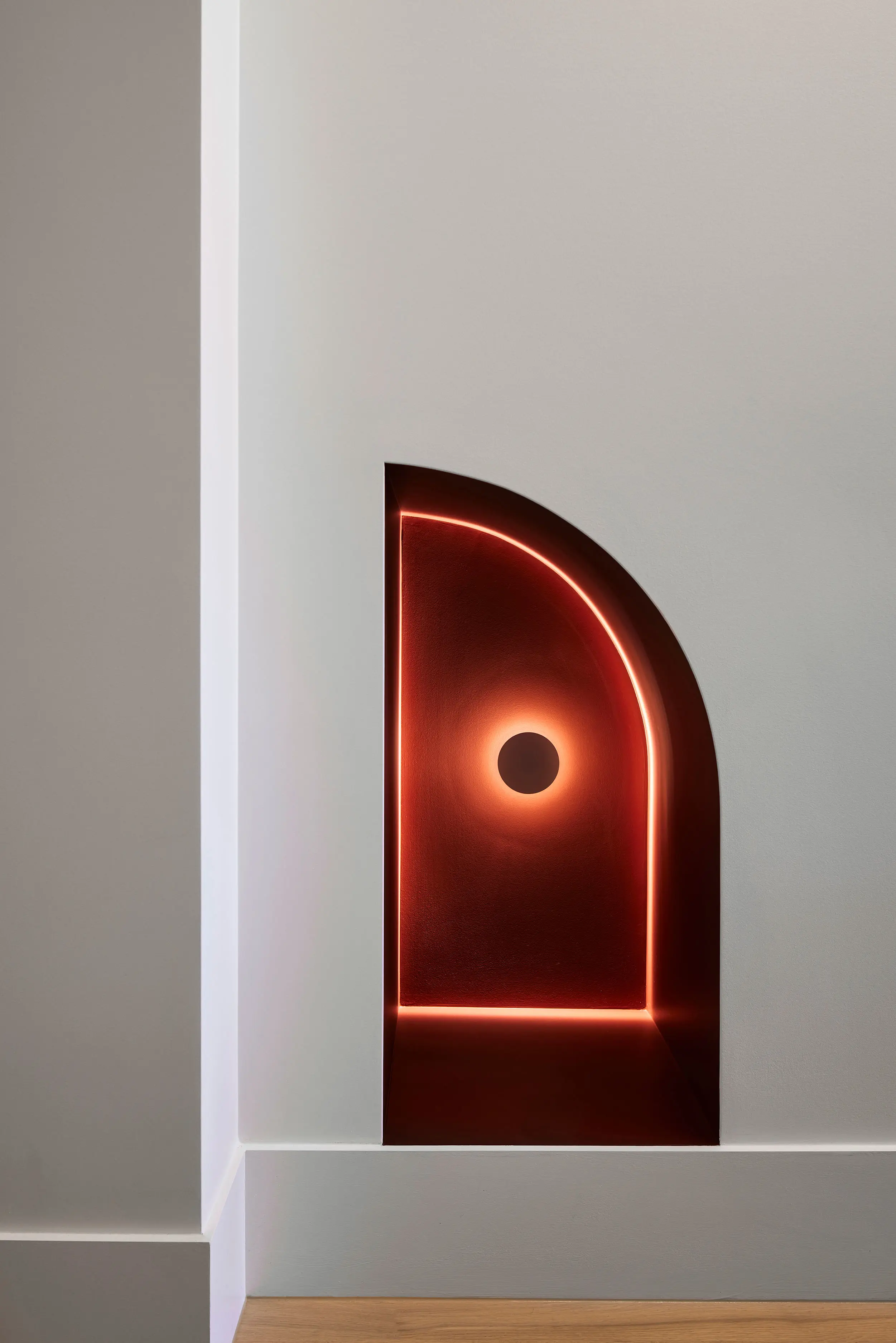 Red arch and light on white wall