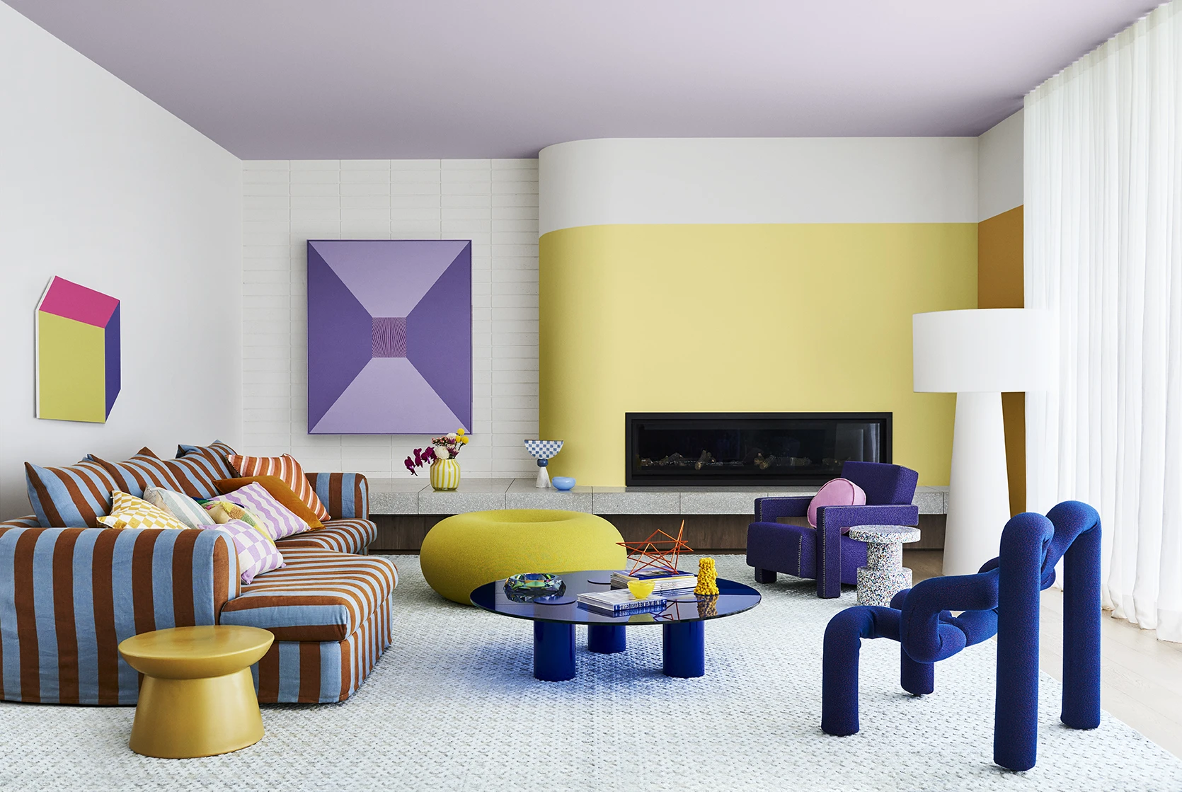 White and yellow living room with purple artwork and modern furniture.