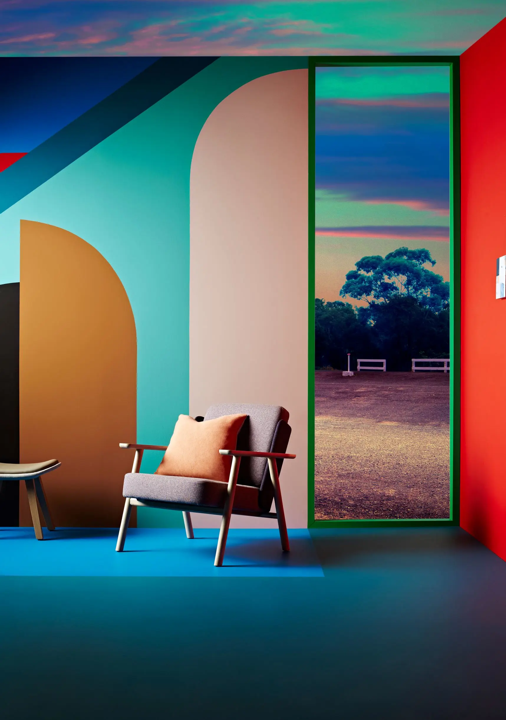 Blue flooring with armchair and colourful wall