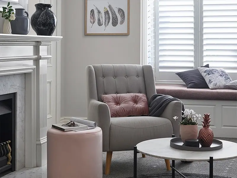 interior lounge room with grey couch and table.