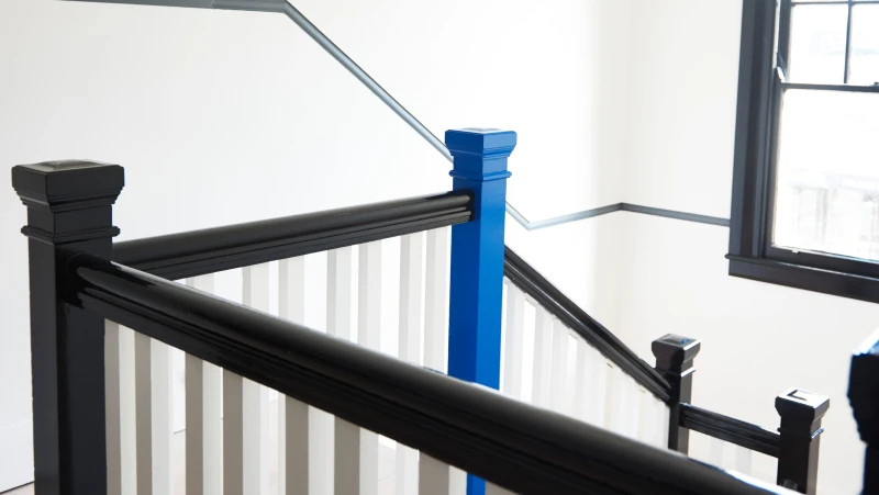 Black and white balustrade with one blue post.