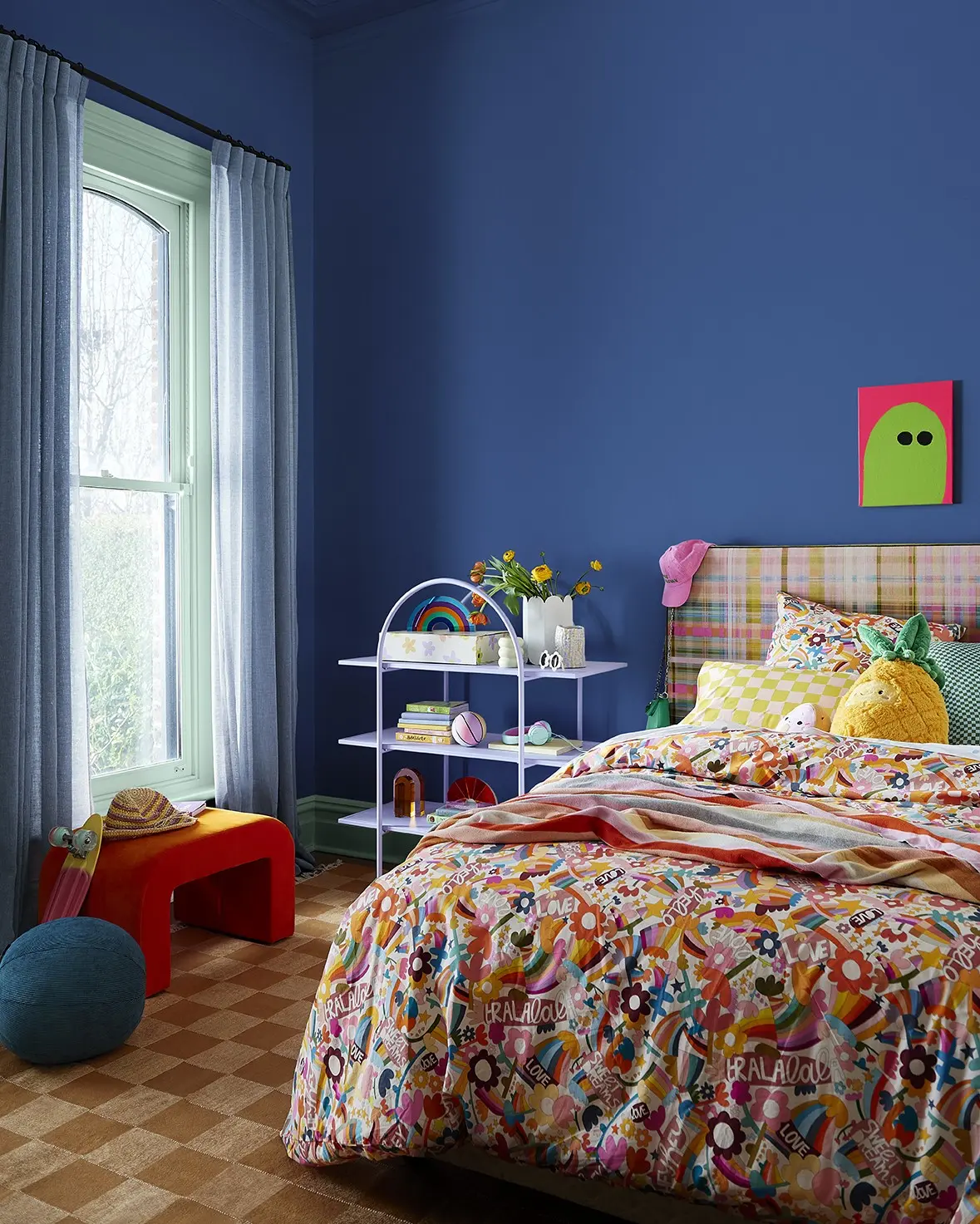 Royal blue child's bedroom with colourful linen