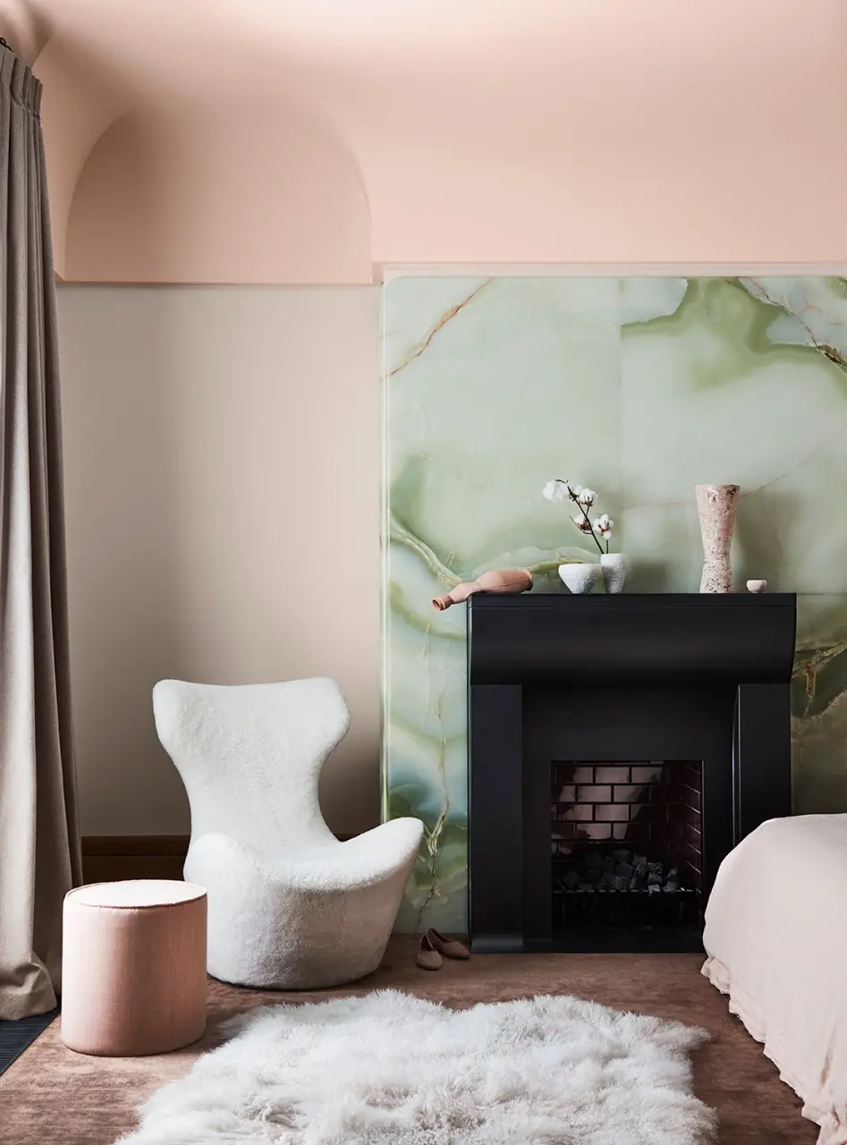 interior bedroom pink and green with white chair.