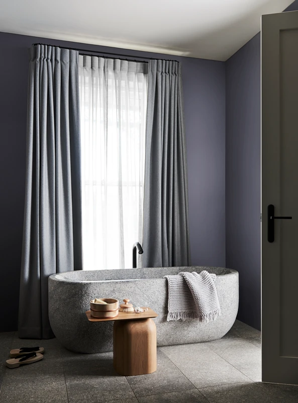 interior bathroom, curtains and stone bathtub.