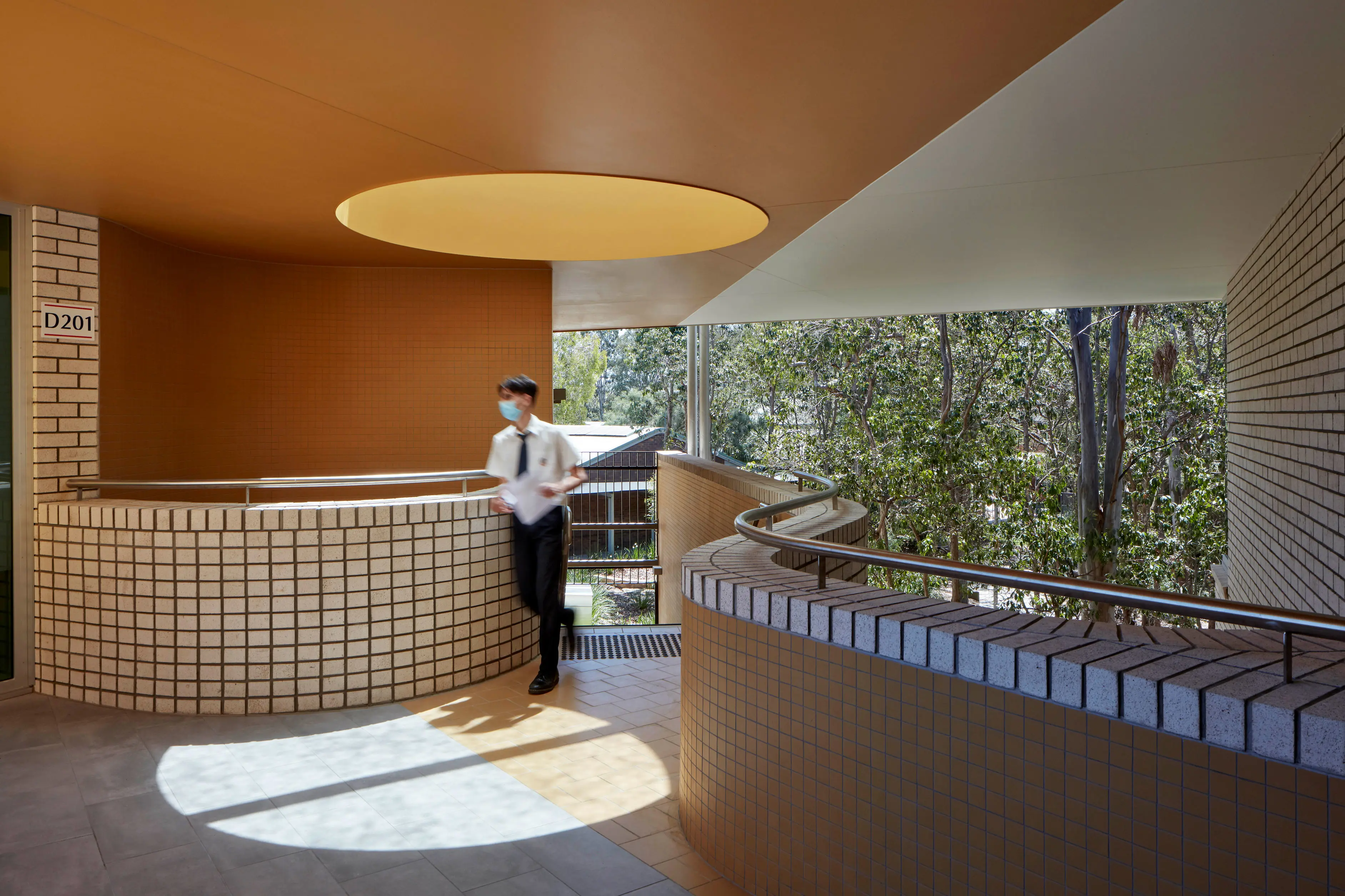 Open plan indoor school area with orange ceiling