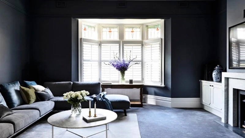 Grey living room with white trim and bay window