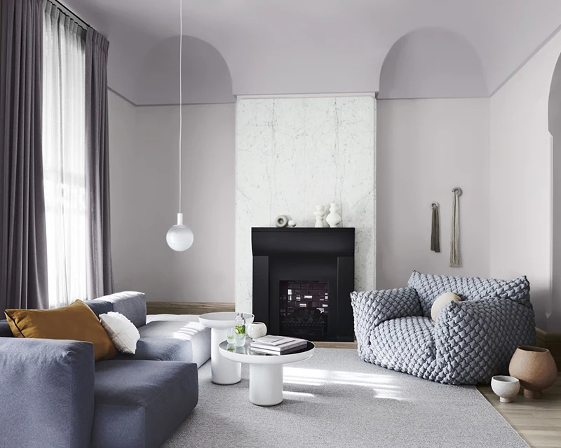 Purple and white living room with grey couches.