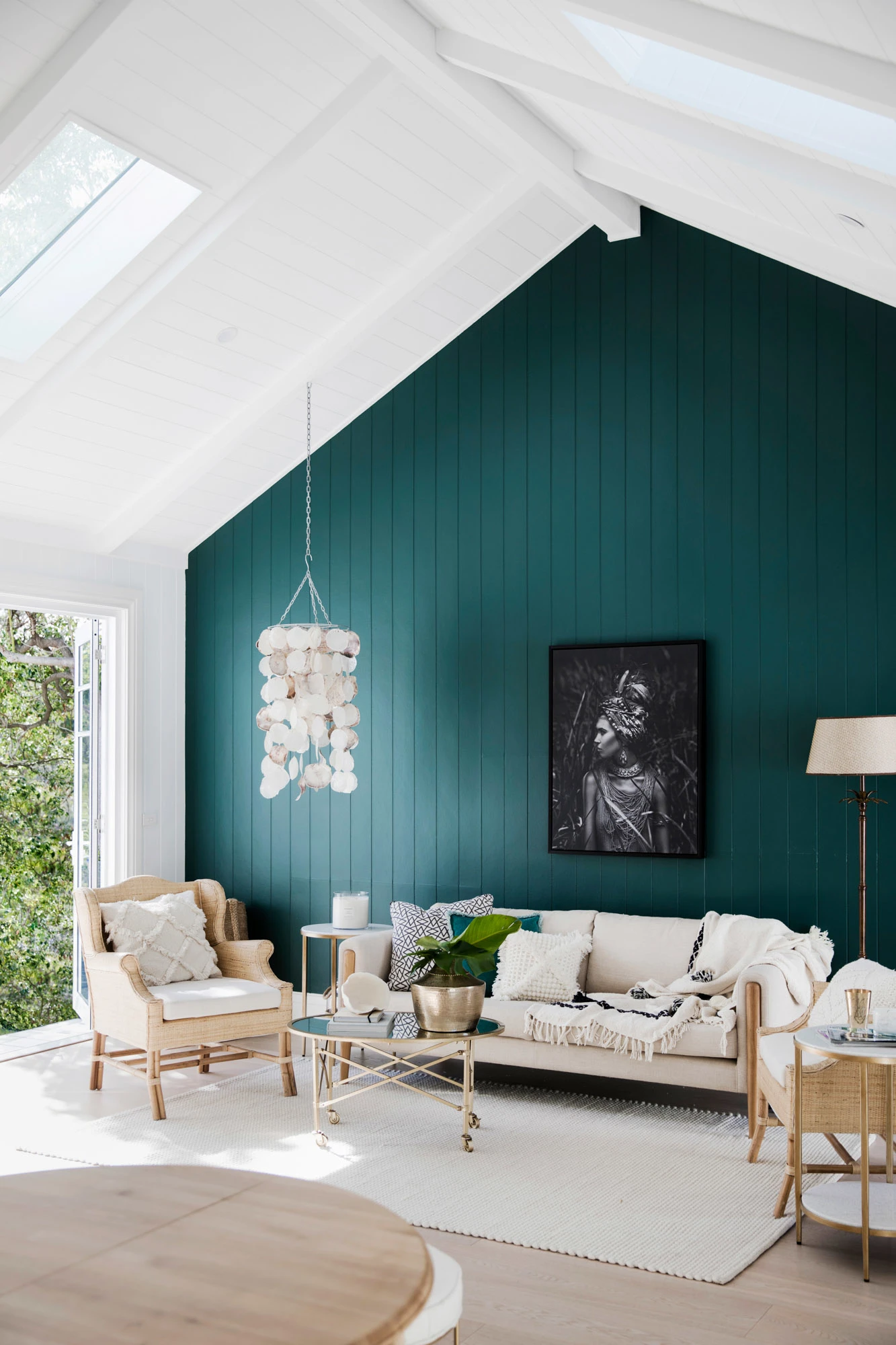 Living are with pitched white ceiling and deep green wall