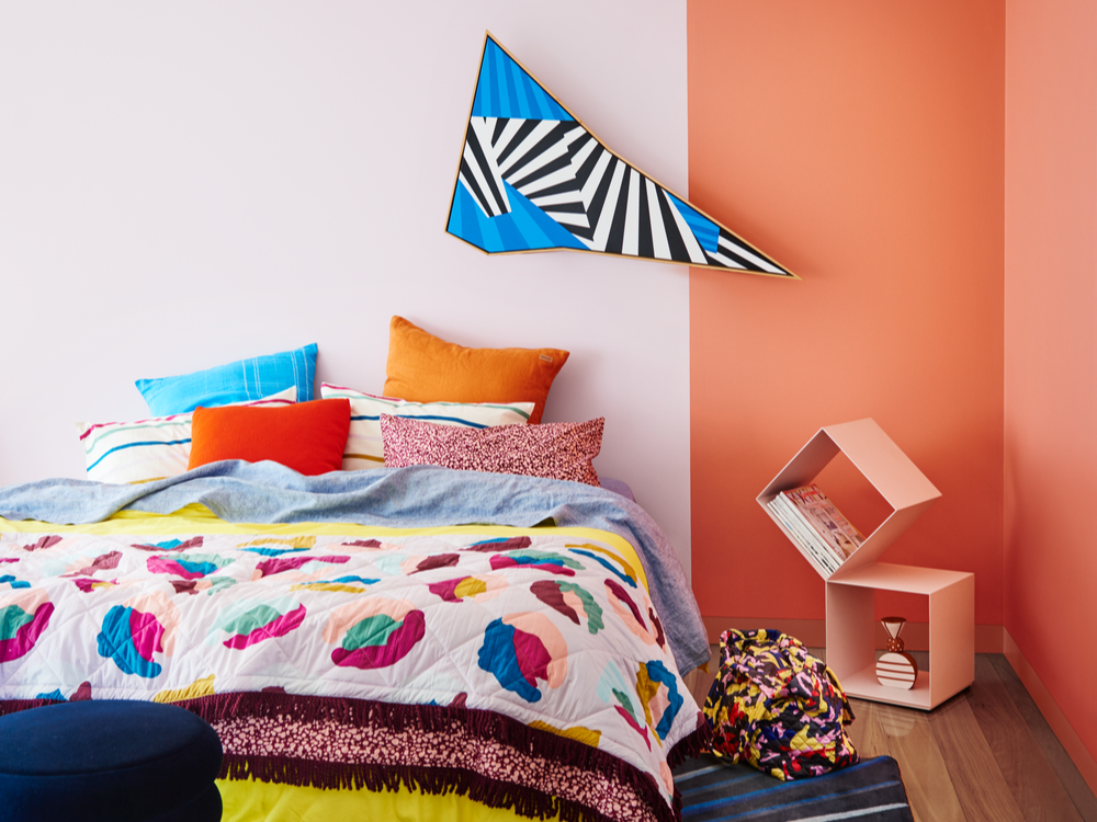 Kid's bedroom, grid bedding, bunny toy and white wall with blue half.