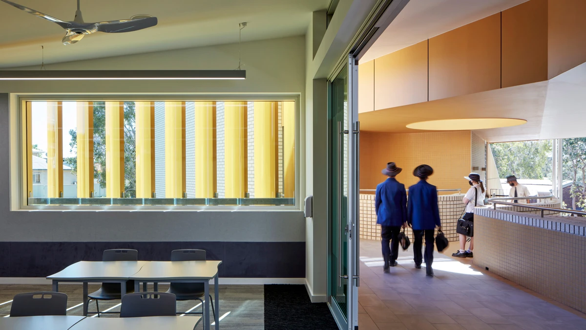 Lunch area and walkway to right with students walking. 